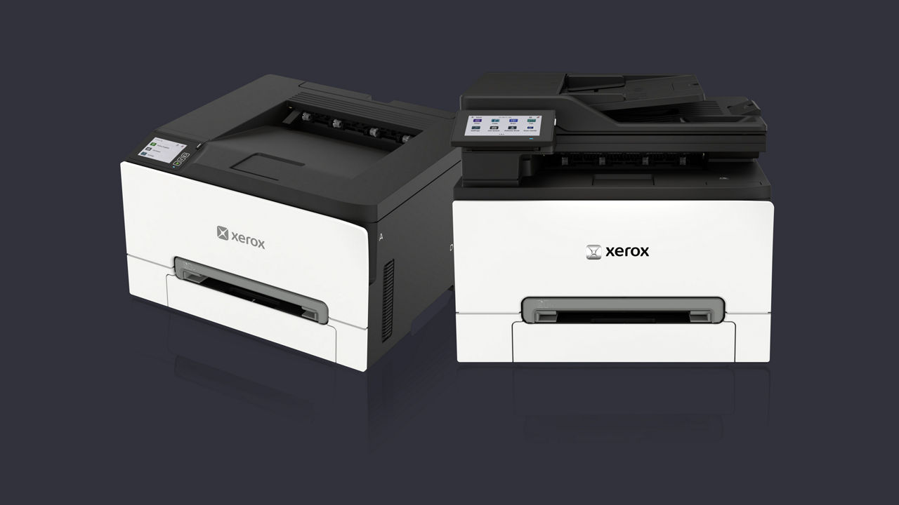 Xerox C3025ae and C2432 side by side on dark gray background
