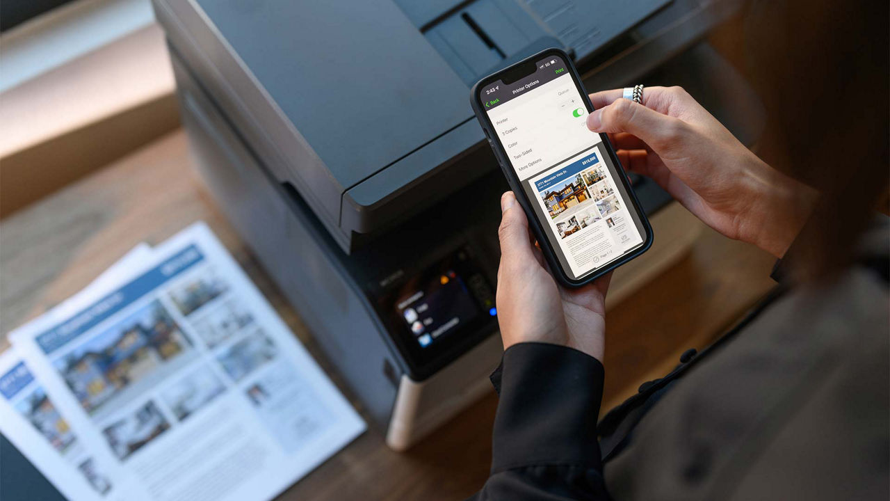 person printing on Lexmark printer using mobile phone