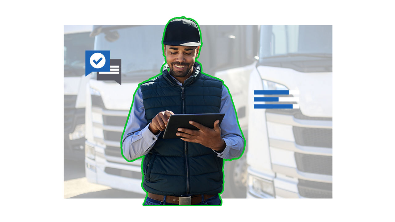 Man standing in front of trucks with tablet