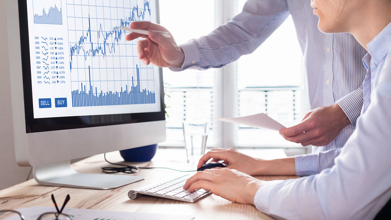 people-looking-at-graph-data-on-monitor