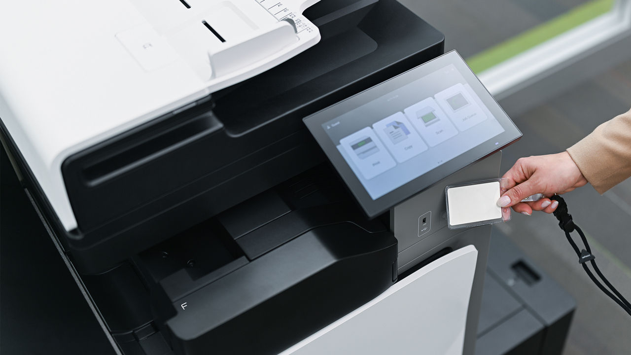 person using badge ID to access Lexmark printer