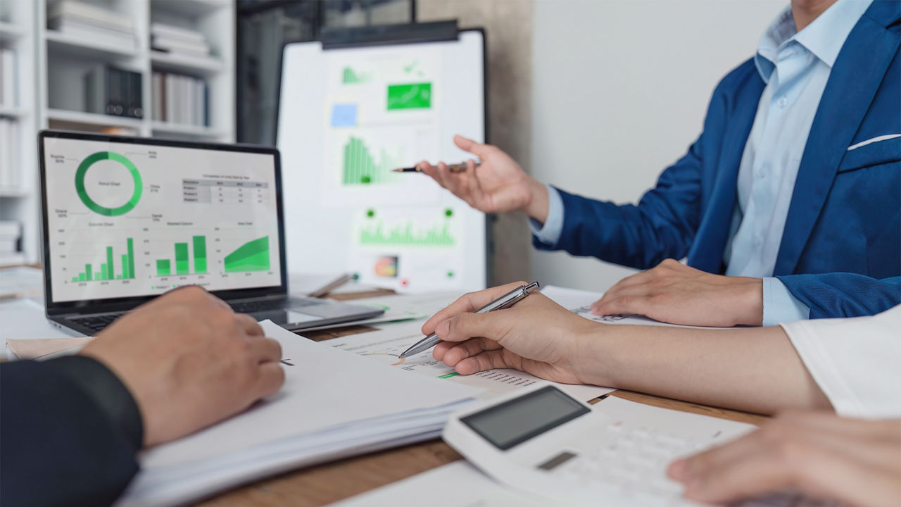 a team discussing data shown in a computer